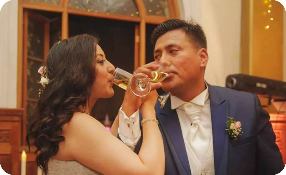 Newlyweds drinking champagne and sharing a toast during their wedding reception.