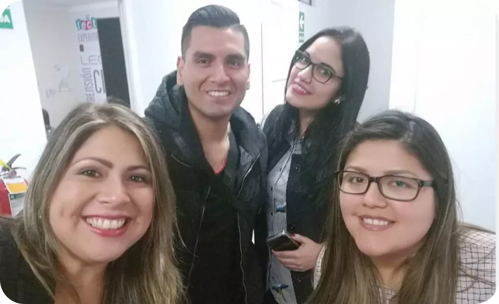 Magaly Ponce with three friends smiling and posing for the camera in an indoor setting.